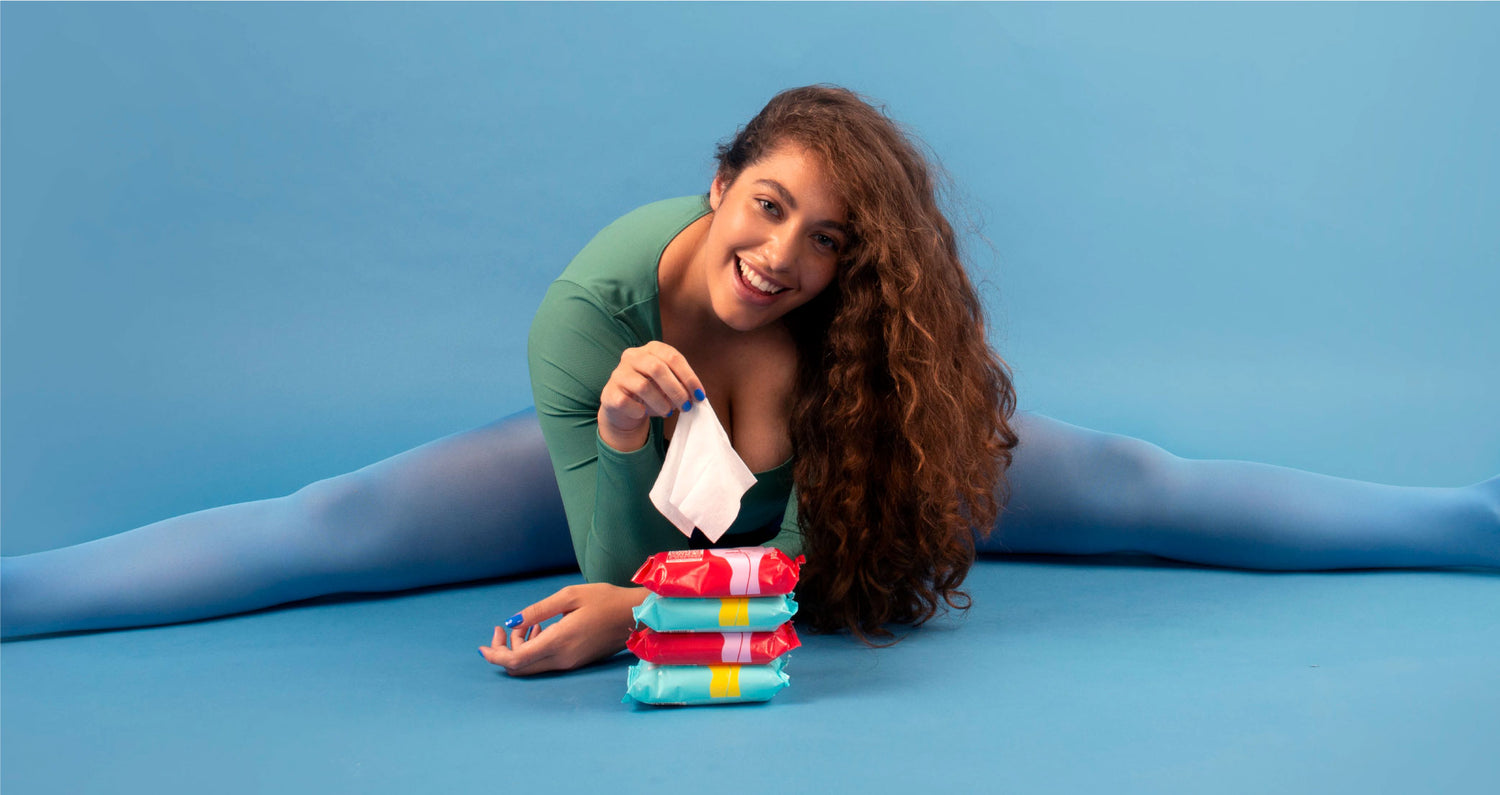 Model doing the splits behind a pile of intimate wipes